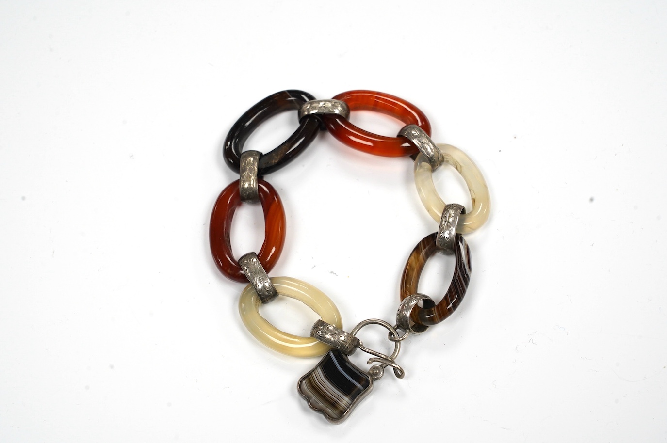 A white metal, carnelian and banded agate set loop link bracelet, 14cm. Condition - poor